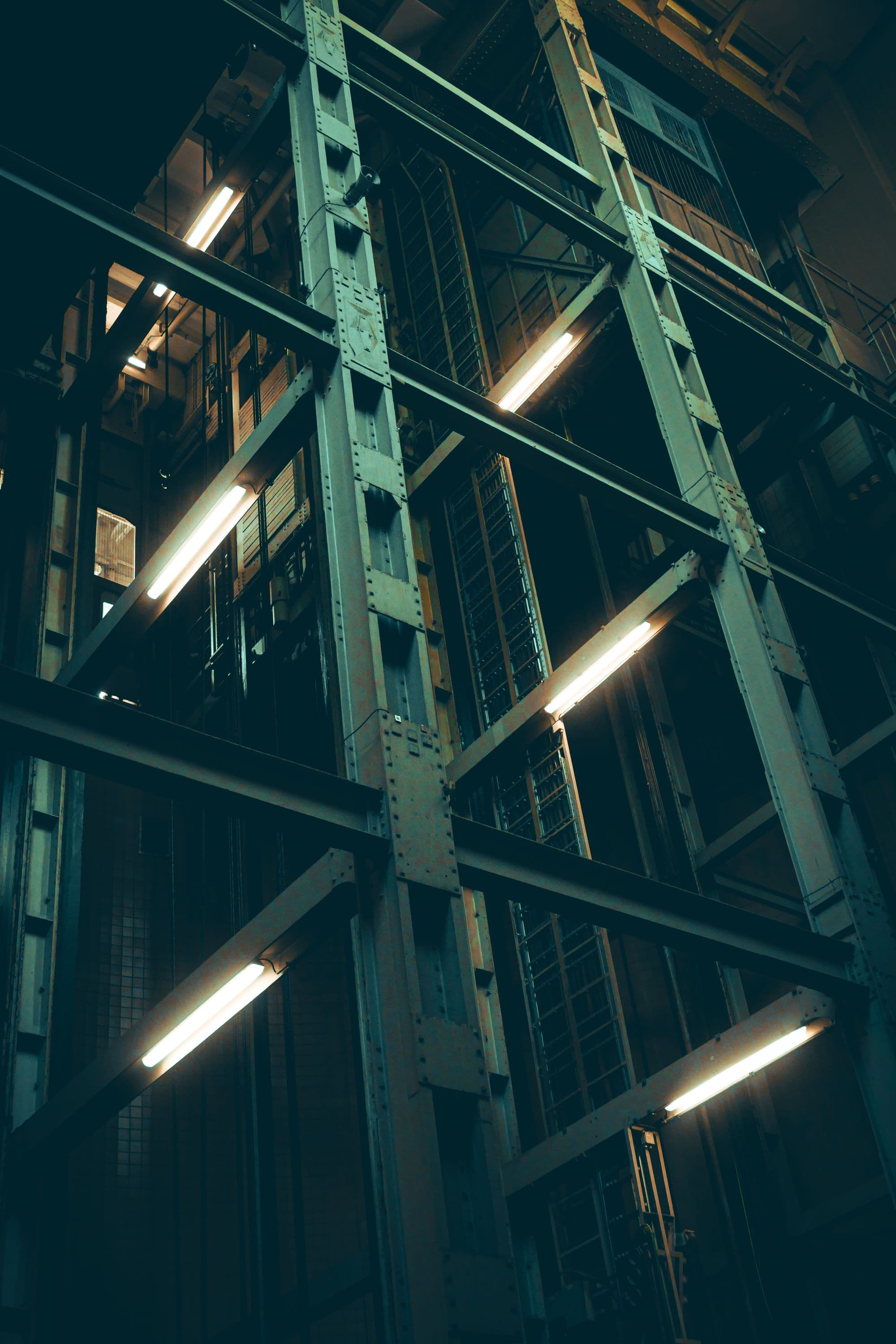 Riveted steel structure and fluorescent light inside the converted industrial building.