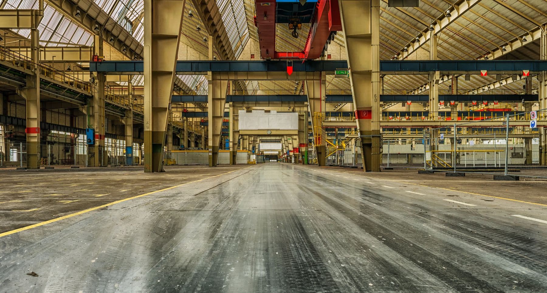 Long painted floor line through an empty warehouse bay used as a sled run.